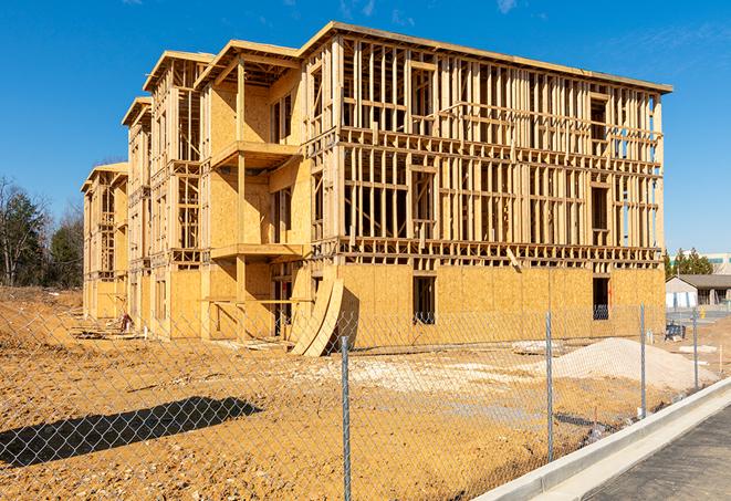 a temporary chain link fence in front of a building under construction, ensuring public safety in Irvine CA